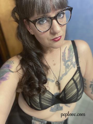 Emily Lane in bra and glasses